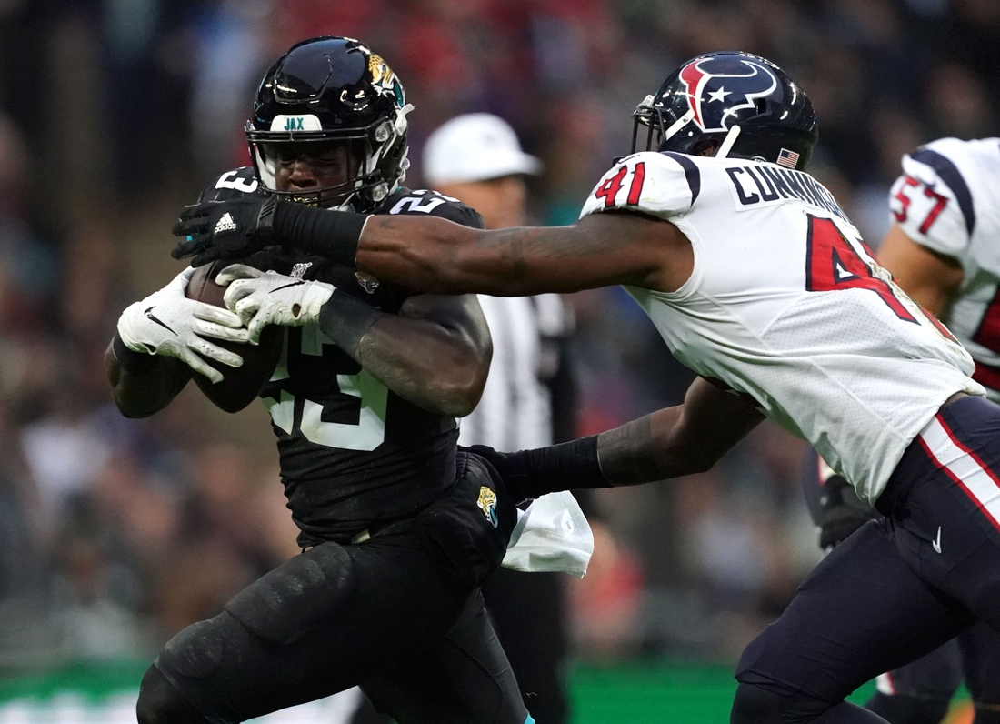 Nov 3, 2019; London, United Kingdom; Jacksonville Jaguars running back Ryquell Armstead (23) is defended by Houston Texans inside linebacker Zach Cunningham (41) in the second half during an NFL International Series game at Wembley Stadium.  The Texans defeated the Jaguars 26-3. Mandatory Credit: Kirby Lee-USA TODAY Sports