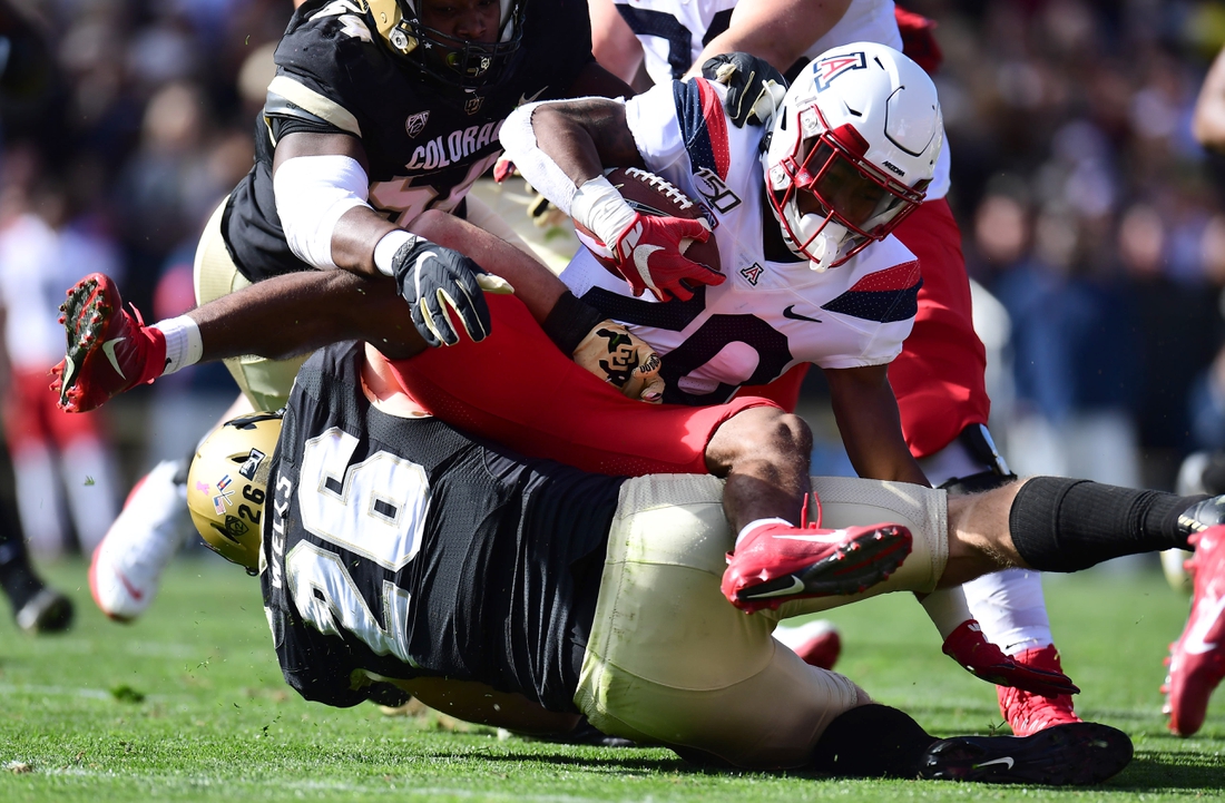 Oct 5, 2019; Boulder, CO, USA; Colorado Buffaloes linebacker Carson Wells (26) tackles Arizona Wildcats running back Darrius Smith (20) in the first quarter at Folsom Field. Mandatory Credit: Ron Chenoy-USA TODAY Sports