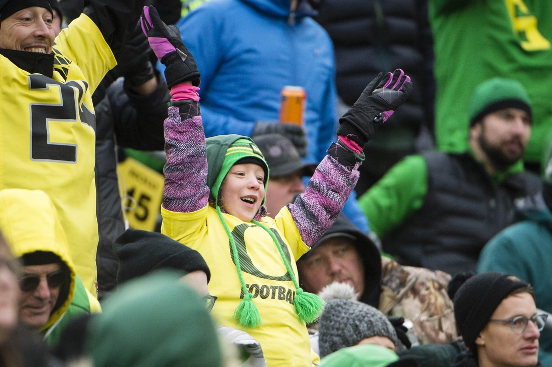 Nov 30, 2019; Eugene, OR, USA; A young Oregon Ducks fan cheers for a t-shirt during the second half against the Oregon State Beavers at Autzen Stadium. The Oregon Ducks beat the Oregon State Beavers 24-10. Mandatory Credit: Troy Wayrynen-USA TODAY Sports