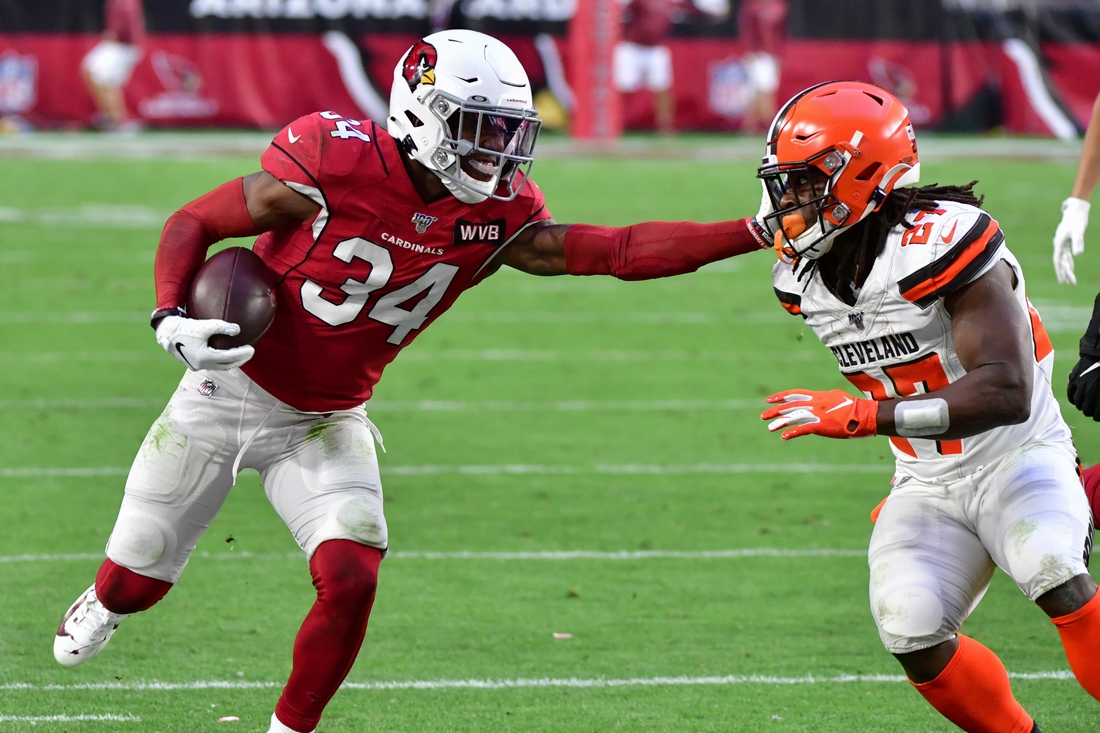 Dec 15, 2019; Glendale, AZ, USA; Arizona Cardinals safety Jalen Thompson (34) carries the ball after recovering a fumble as Cleveland Browns running back Kareem Hunt (27) defends during the second half at State Farm Stadium. Mandatory Credit: Matt Kartozian-USA TODAY Sports