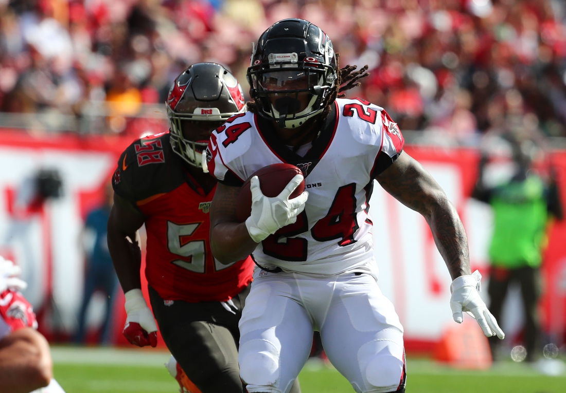 Dec 29, 2019; Tampa, Florida, USA; Atlanta Falcons running back Devonta Freeman (24) runs with the ball against the Tampa Bay Buccaneers during the first quarter at Raymond James Stadium. Mandatory Credit: Kim Klement-USA TODAY Sports