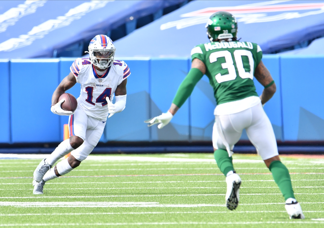 Sep 13, 2020; Orchard Park, New York, USA; Buffalo Bills wide receiver Stefon Diggs (14) sqares off against New York Jets strong safety Bradley McDougald (30) trying to avoid a tackle after making a catch in the third quarter at Bills Stadium. Mandatory Credit: Mark Konezny-USA TODAY Sports