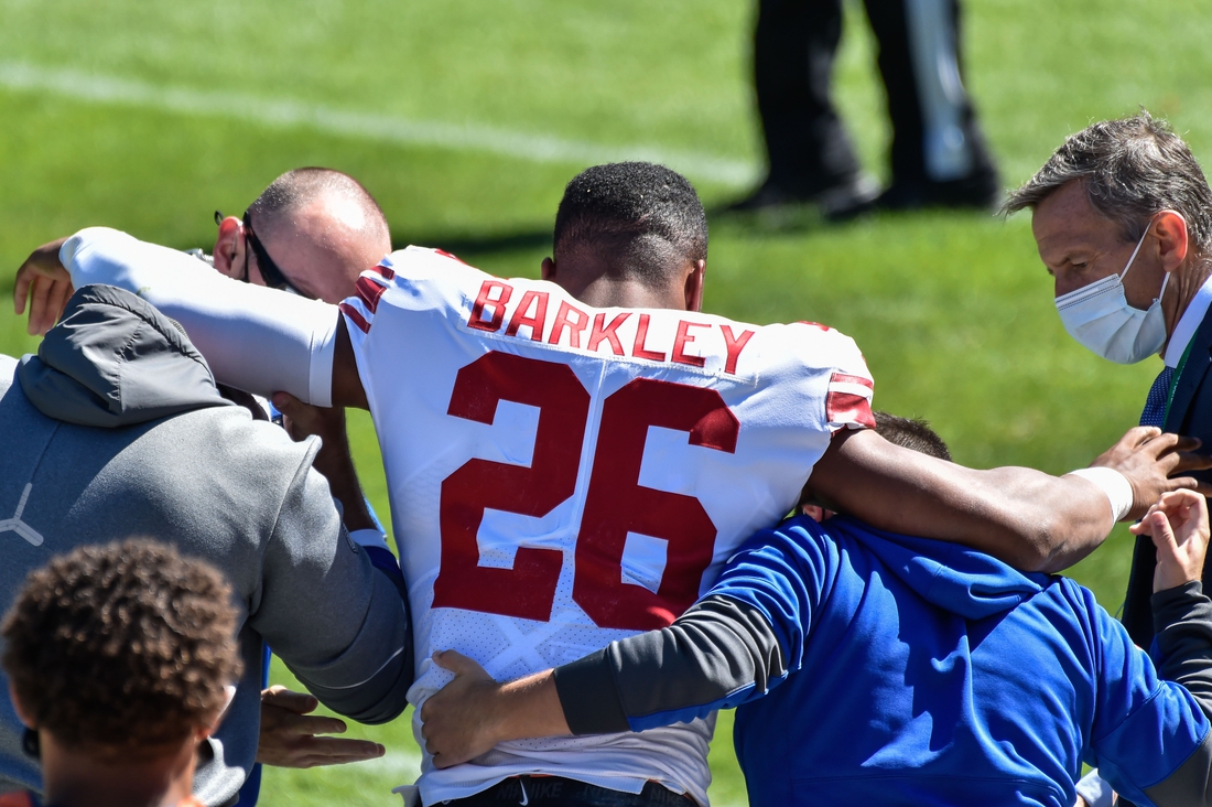 Sep 20, 2020; Chicago, Illinois, USA; New York Giants running back Saquon Barkley (26) is helped off of the field after suffering an injury during the second quarter against the Chicago Bears at Soldier Field. Mandatory Credit: Jeffrey Becker-USA TODAY Sports