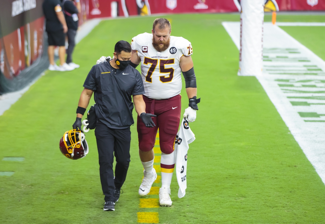 Sep 20, 2020; Glendale, Arizona, USA; Washington Football Team guard Brandon Scherff (75) is helped off the field to the locker room by a trainer after suffering an injury against the Arizona Cardinals at State Farm Stadium. Mandatory Credit: Mark J. Rebilas-USA TODAY Sports