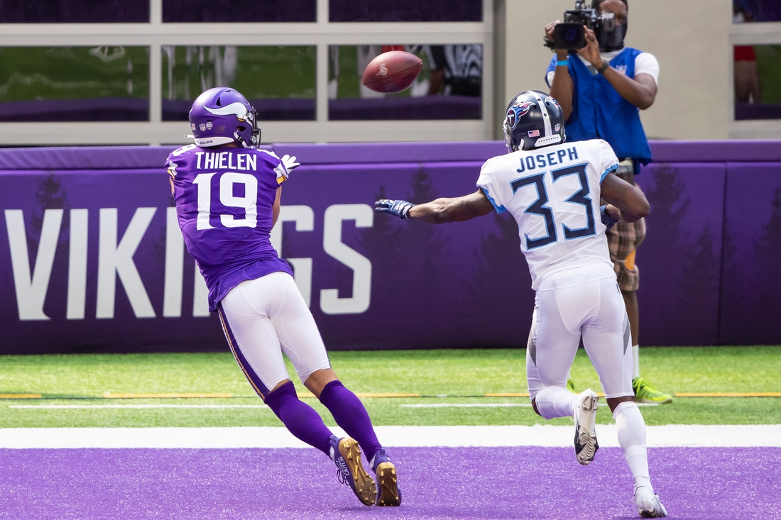 Sep 27, 2020; Minneapolis, Minnesota, USA; Minnesota Vikings wide receiver Adam Thielen (19) catches a pass for a touchdown in the second quarter against the Tennessee Titans defensive back Johnathan Joseph  (33) at U.S. Bank Stadium. Mandatory Credit: Brad Rempel-USA TODAY Sports