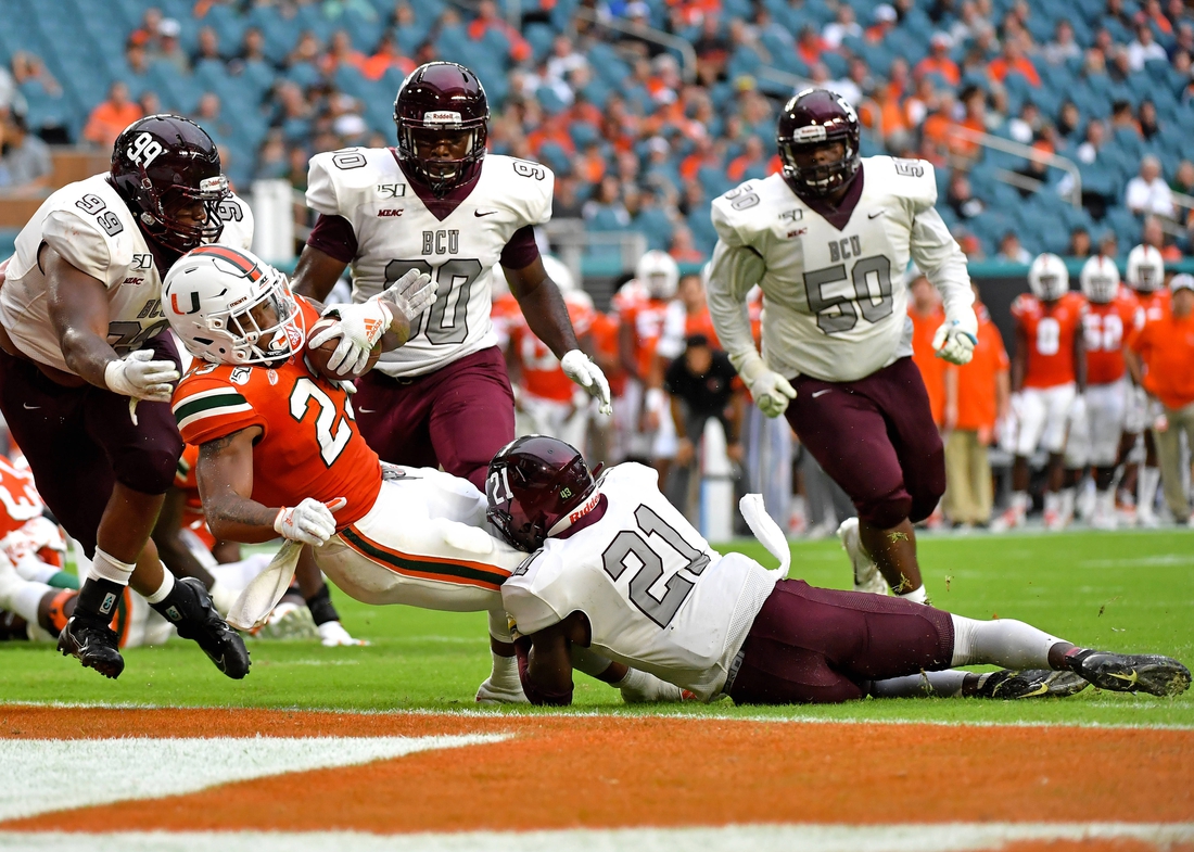 Sep 14, 2019; Miami Gardens, FL, USA; Miami Hurricanes running back Cam'Ron Harris (23) scores a touchdown against Bethune Cookman Wildcats safety Tydarius Peters (21) during the second half at Hard Rock Stadium. Mandatory Credit: Steve Mitchell-USA TODAY Sports