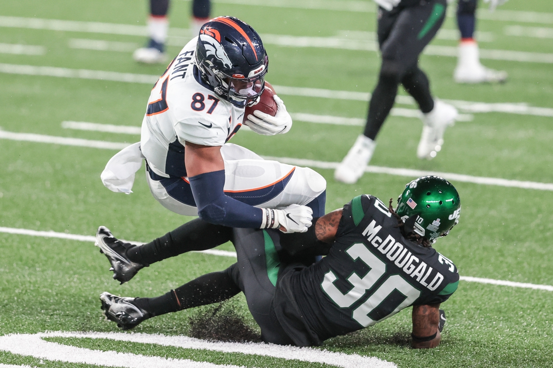 Oct 1, 2020; East Rutherford, New Jersey, USA; Denver Broncos tight end Noah Fant (87) is tackled by New York Jets strong safety Bradley McDougald (30) during the second half at MetLife Stadium. Mandatory Credit: Vincent Carchietta-USA TODAY Sports