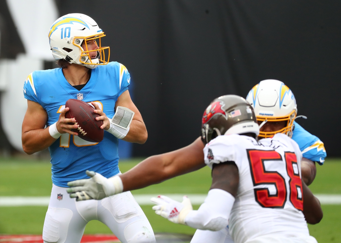 Oct 4, 2020; Tampa, Florida, USA; Los Angeles Chargers quarterback Justin Herbert (10) throws a pass against the Tampa Bay Buccaneers in the second quarter of a NFL game at Raymond James Stadium. Mandatory Credit: Kim Klement-USA TODAY Sports