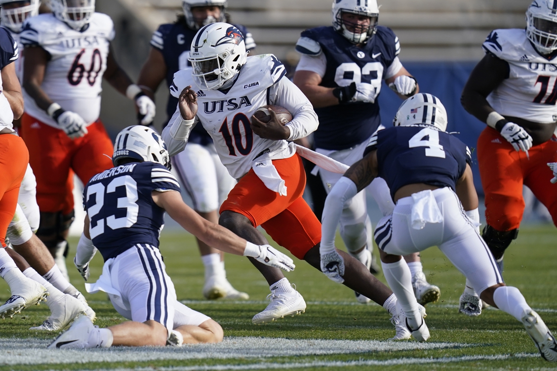 Oct 10, 2020; Provo, UT, USA; UTSA quarterback Lowell Narcisse (10) carries the ball as BYU s Zayne Anderson (23) and Troy Warner (4) close in for a tackle in the second half during an NCAA college football game Saturday, Oct. 10, 2020, in Provo, Utah.   Mandatory Credit: Rick Bowmer/Pool Photo-USA TODAY Sports