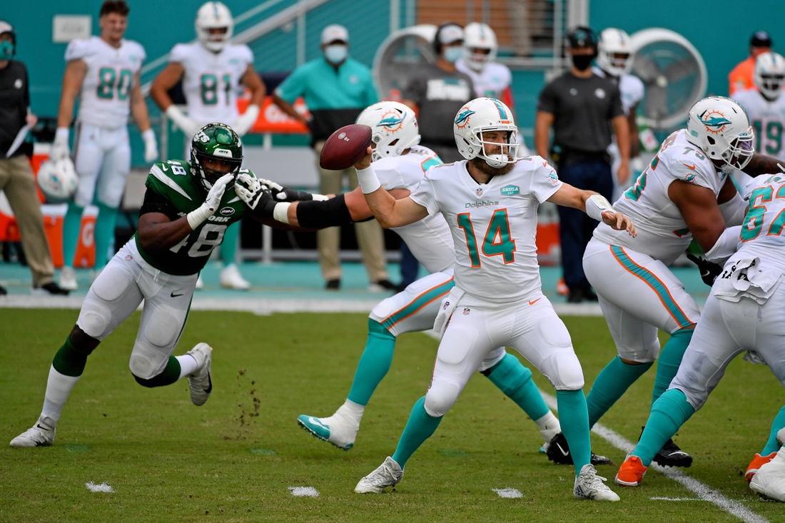 Oct 18, 2020; Miami Gardens, Florida, USA; Miami Dolphins quarterback Ryan Fitzpatrick (14) attempts a pass against the New York Jets during the first half at Hard Rock Stadium. Mandatory Credit: Jasen Vinlove-USA TODAY Sports