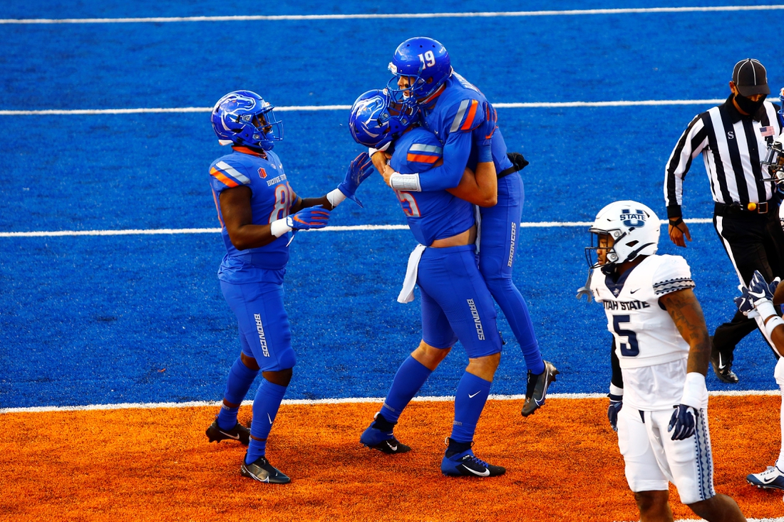Oct 24, 2020; Boise, Idaho, USA;  Boise State Broncos quarterback Hank Bachmeier (19) celebrates a touchdown run with teammates during the first half versus the Utah State Aggies at Albertsons Stadium. Mandatory Credit: Brian Losness-USA TODAY Sports