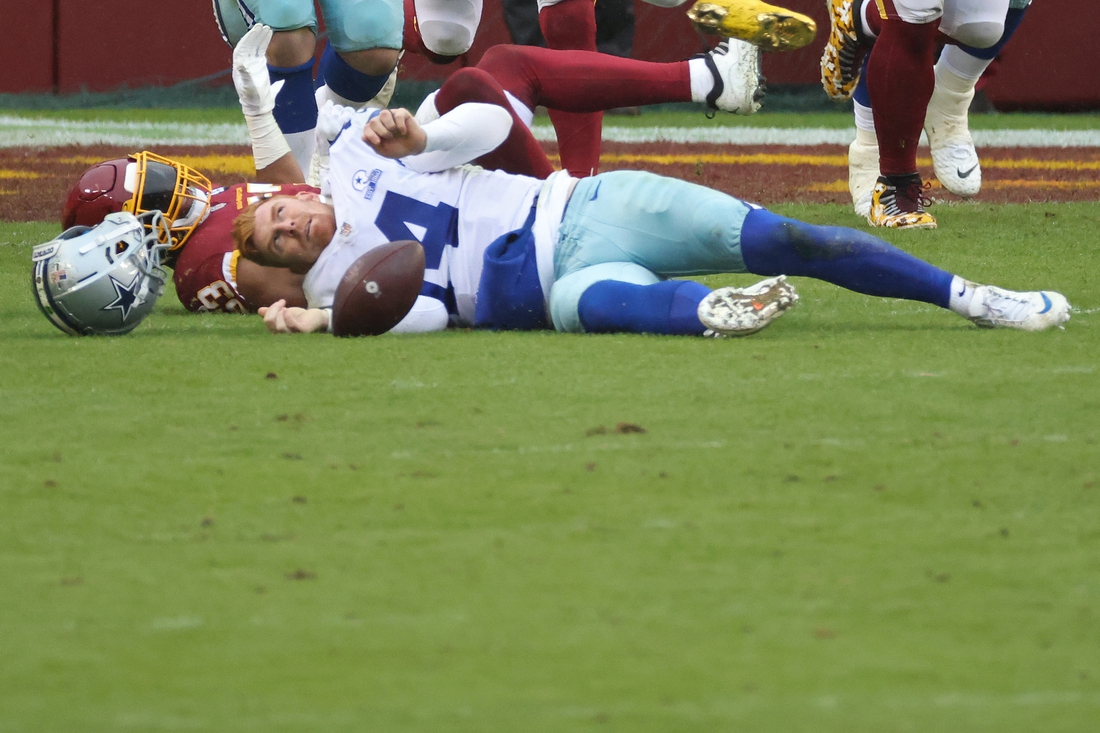 Oct 25, 2020; Landover, Maryland, USA; Dallas Cowboys quarterback Andy Dalton (14) is hit by Washington Football Team inside linebacker Jon Bostic (53) and knocked out of the game in the third quarter at FedExField. Mandatory Credit: Geoff Burke-USA TODAY Sports
