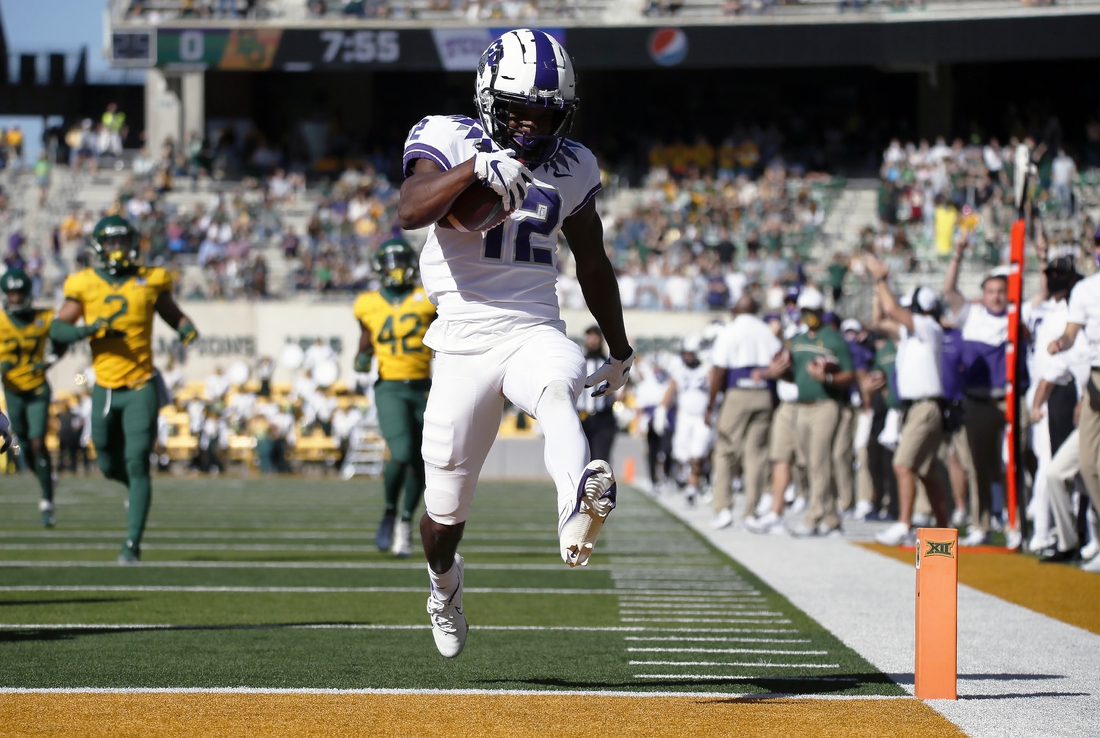 Oct 31, 2020; Waco, Texas, USA; TCU Horned Frogs wide receiver Derius Davis (12) heads for the end zone on a 66-yard punt return for touchdown during the first half at McLane Stadium. Mandatory Credit: Raymond Carlin III-USA TODAY Sports