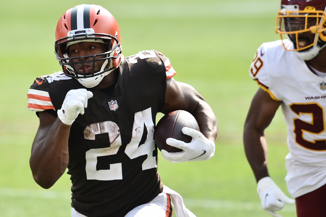 Sep 27, 2020; Cleveland, Ohio, USA; Cleveland Browns running back Nick Chubb (24) runs with the ball asWashington Football Team cornerback Kendall Fuller (29) defends during the second half at FirstEnergy Stadium. Mandatory Credit: Ken Blaze-USA TODAY Sports