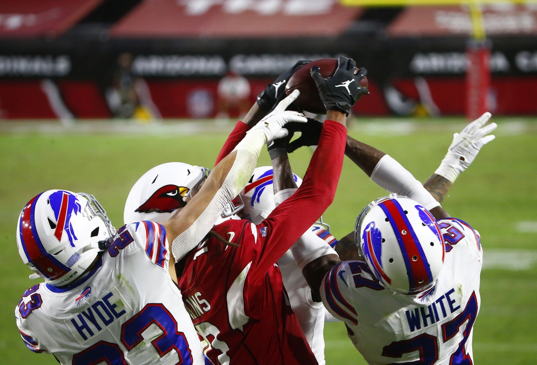 Nov 15, 2020; Glendale, Arizona, USA; Arizona Cardinals wide receiver DeAndre Hopkins (center) catches a Hail Mary pass for a touchdown in the closing seconds of the game against the Buffalo Bills at State Farm Stadium. Mandatory Credit: Patrick Breen-USA TODAY NETWORK