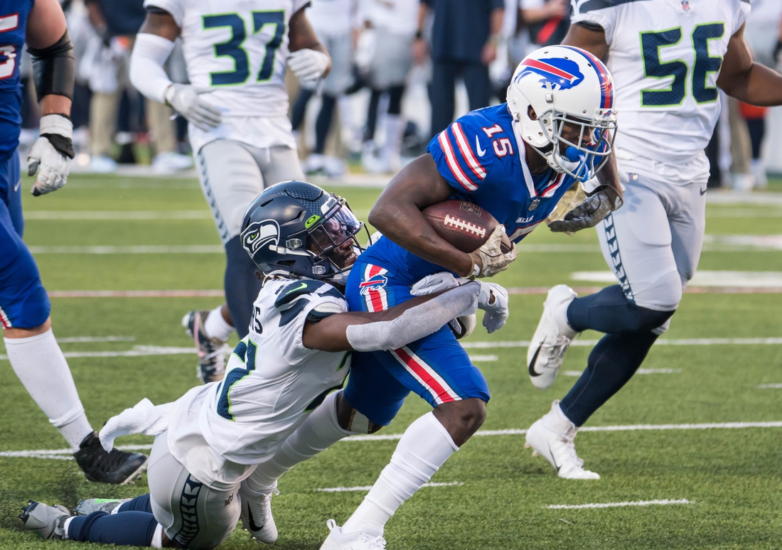 Nov 8, 2020; Orchard Park, New York, USA; Buffalo Bills wide receiver John Brown (15) is tackled by Seattle Seahawks cornerback Tre Flowers (21) after making a catch in the fourth quarter at Bills Stadium. Mandatory Credit: Mark Konezny-USA TODAY Sports