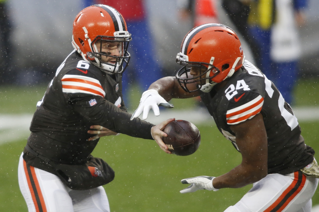 Nov 22, 2020; Cleveland, Ohio, USA; Cleveland Browns quarterback Baker Mayfield (6) hands off to running back Nick Chubb (24) during the first quarter against the Philadelphia Eagles at FirstEnergy Stadium. Mandatory Credit: Scott Galvin-USA TODAY Sports