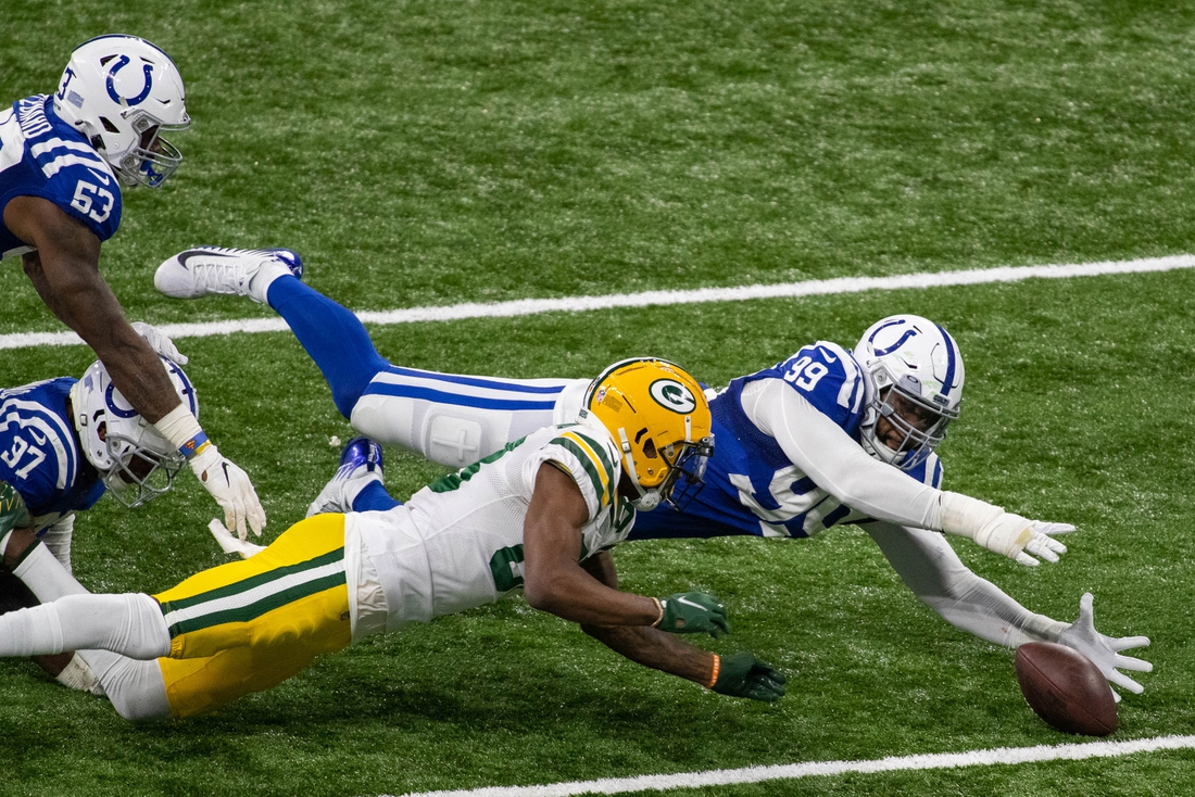 Nov 22, 2020; Indianapolis, Indiana, USA; Indianapolis Colts defensive tackle DeForest Buckner (99) dives on a loose ball against Green Bay Packers wide receiver Marquez Valdes-Scantling (83) in overtime at Lucas Oil Stadium. Mandatory Credit: Trevor Ruszkowski-USA TODAY Sports