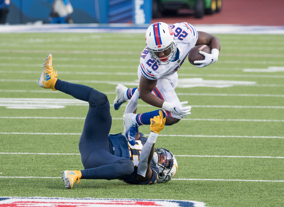 Nov 29, 2020; Orchard Park, New York, USA; Buffalo Bills running back Devin Singletary (26) is tackled by Los Angeles Chargers strong safety Rayshawn Jenkins (23) in the second quarter at Bills Stadium. Mandatory Credit: Mark Konezny-USA TODAY Sports