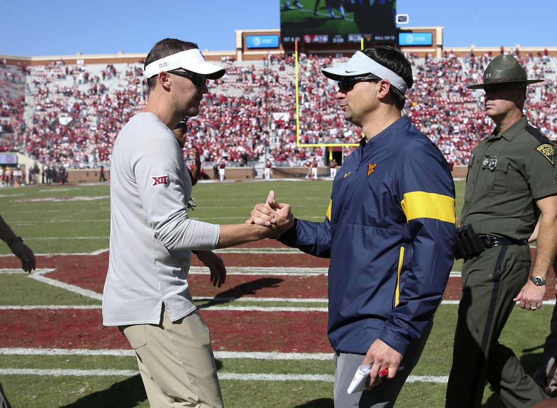 Oct 19, 2019; Norman, OK, USA; Oklahoma Sooners head coach Lincoln Riley (left) greets West Virginia Mountaineers head coach Neal Brown after the game at Gaylord Family - Oklahoma Memorial Stadium. Mandatory Credit: Kevin Jairaj-USA TODAY Sports