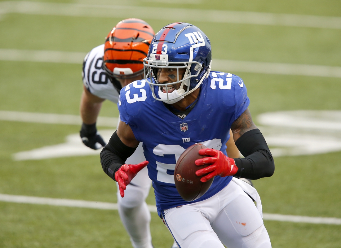 Nov 29, 2020; Cincinnati, Ohio, USA; New York Giants free safety Logan Ryan (23) runs with the ball after recovering the forced fumble during the fourth quarter against the Cincinnati Bengals at Paul Brown Stadium. Mandatory Credit: Joseph Maiorana-USA TODAY Sports