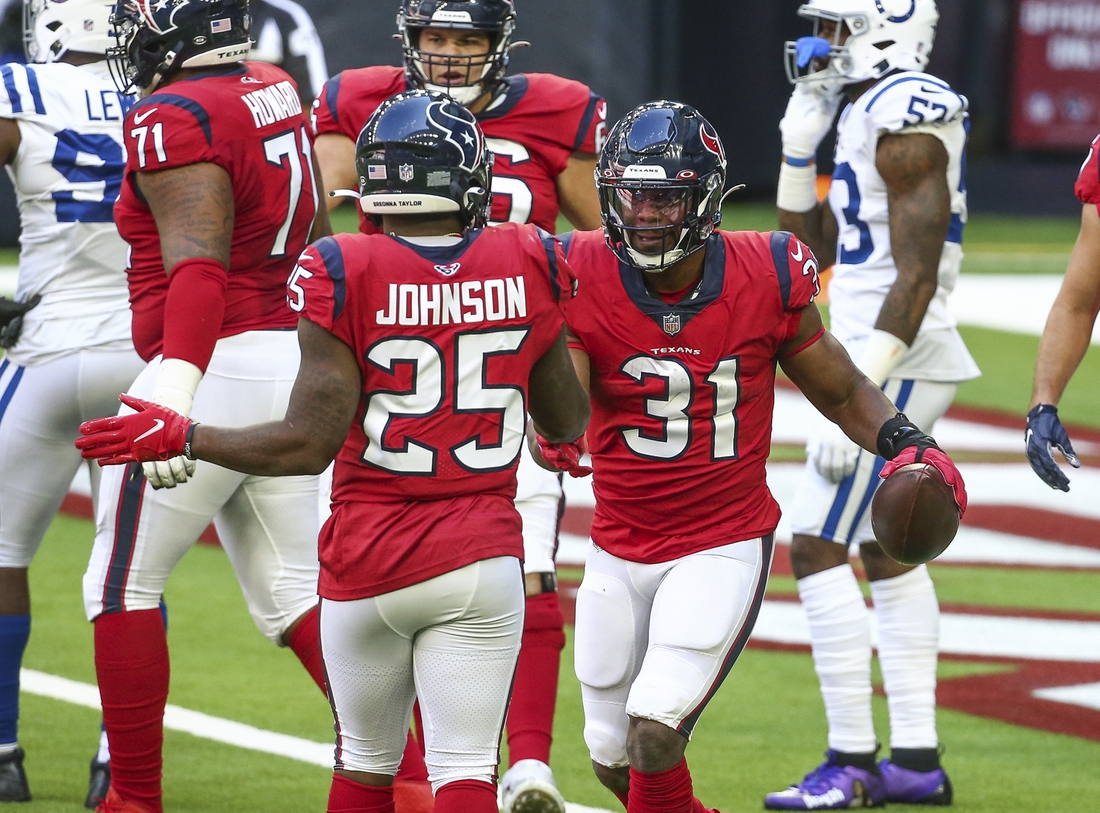 Dec 6, 2020; Houston, Texas, USA; Houston Texans running back David Johnson (31) celebrates with running back Duke Johnson (25) after scoring  a touchdown during the second quarter against the Indianapolis Colts at NRG Stadium. Mandatory Credit: Troy Taormina-USA TODAY Sports