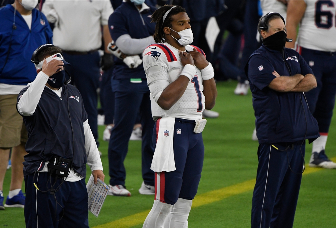 Dec 10, 2020; Inglewood, California, USA; New England Patriots quarterback Cam Newton (middle) looks on from the sidelines with head coach Bill Belichick (right) after being replaced in the fourth quarter against the Los Angeles Rams at SoFi Stadium. Mandatory Credit: Robert Hanashiro-USA TODAY Sports