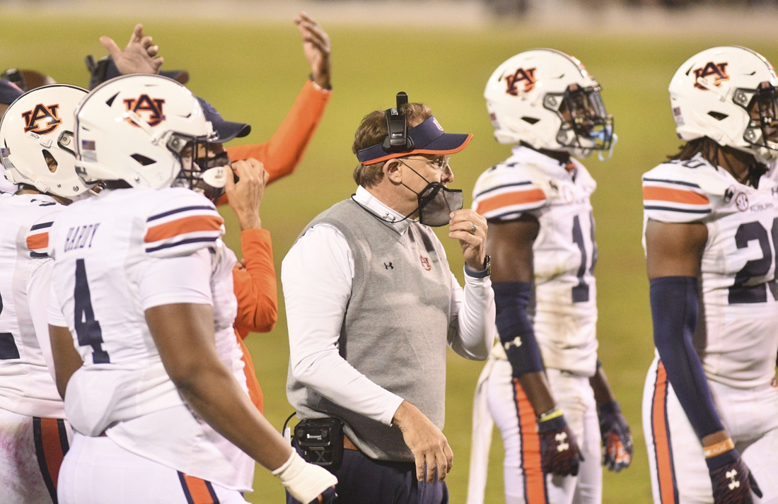 Dec 12, 2020; Starkville, Mississippi, USA; Auburn Tigers head coach Gus Malzahn walks onto the field during a timeout during the fourth quarter of the game against the Mississippi State Bulldogs at Davis Wade Stadium at Scott Field. Mandatory Credit: Matt Bush-USA TODAY Sports