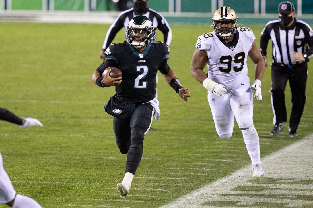 Dec 13, 2020; Philadelphia, Pennsylvania, USA; Philadelphia Eagles quarterback Jalen Hurts (2) runs with the ball past New Orleans Saints defensive tackle Shy Tuttle (99) during the second quarter at Lincoln Financial Field. Mandatory Credit: Bill Streicher-USA TODAY Sports