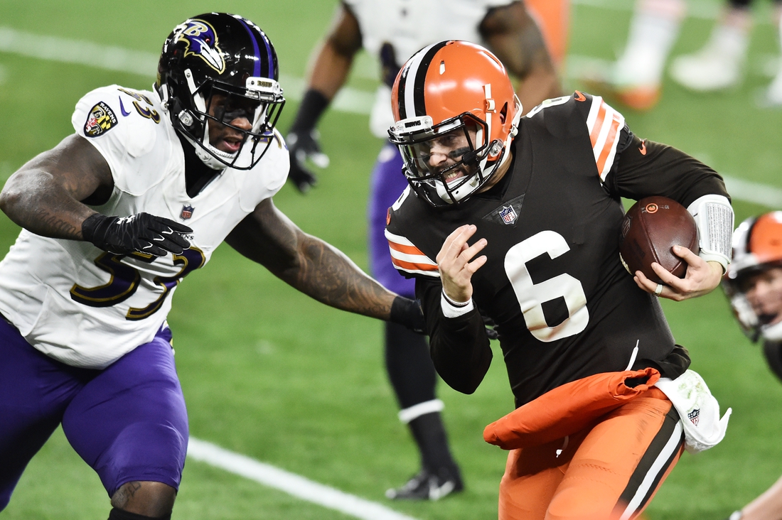 Dec 14, 2020; Cleveland, Ohio, USA; Cleveland Browns quarterback Baker Mayfield (6) runs with the ball as Baltimore Ravens defensive end Jihad Ward (53) defends during the first quarter at FirstEnergy Stadium. Mandatory Credit: Ken Blaze-USA TODAY Sports