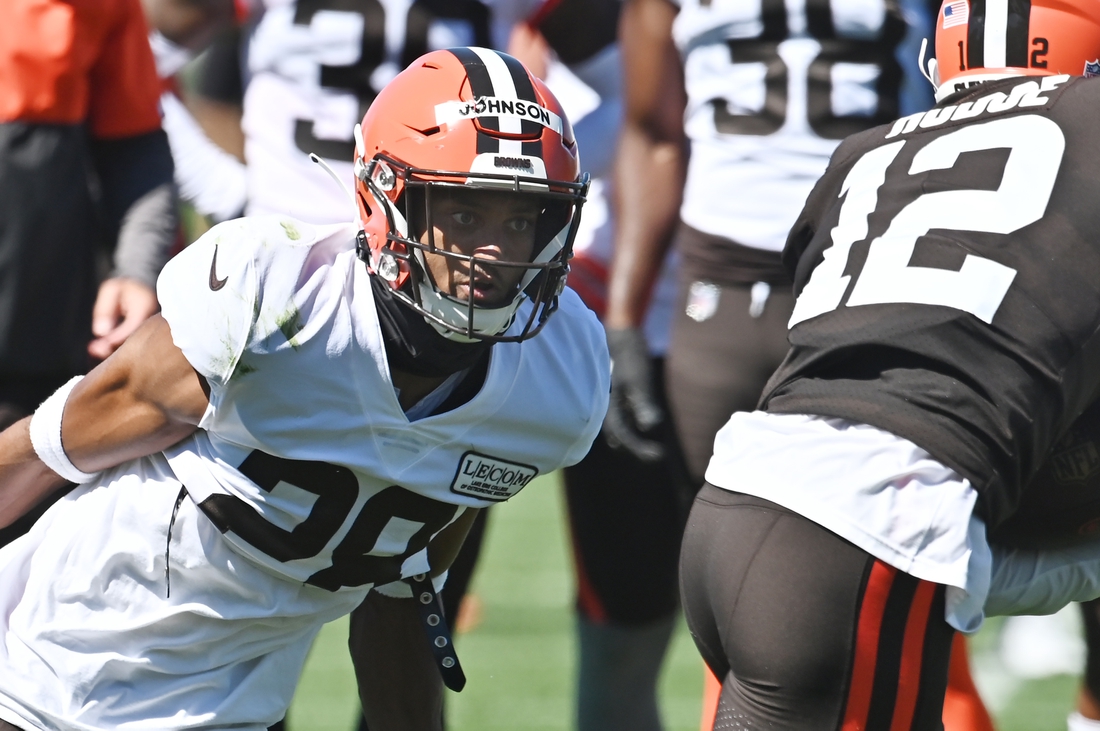 Aug 19, 2020; Berea, Ohio, USA;  Cleveland Browns cornerback Kevin Johnson (28) prepares to tackle wide receiver KhaDarel Hodge (12) during training camp at the Cleveland Browns training facility. Mandatory Credit: Ken Blaze-USA TODAY Sports