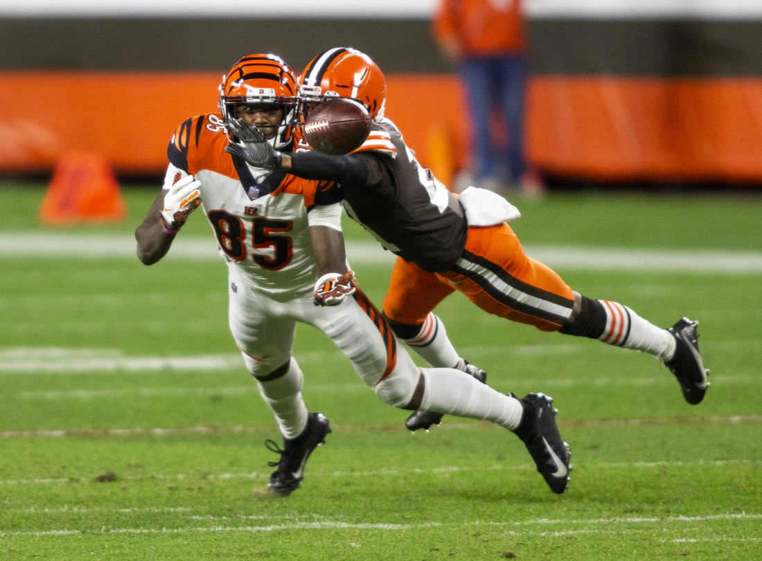 Sep 17, 2020; Cleveland, Ohio, USA; Cleveland Browns cornerback Denzel Ward (21) breaks up a pass intended for Cincinnati Bengals wide receiver Tee Higgins (85) during the fourth quarter at FirstEnergy Stadium. Mandatory Credit: Scott Galvin-USA TODAY Sports