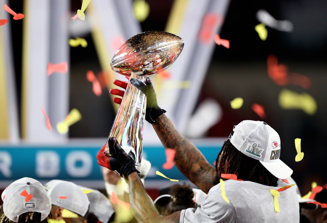 Feb 2, 2020; Miami Gardens, Florida, USA; Detailed view of the Vince Lombardi Trophy in the hands of a Kansas City Chiefs player celebrating after defeating the San Francisco 49ers in Super Bowl LIV at Hard Rock Stadium. Mandatory Credit: Mark J. Rebilas-USA TODAY Sports