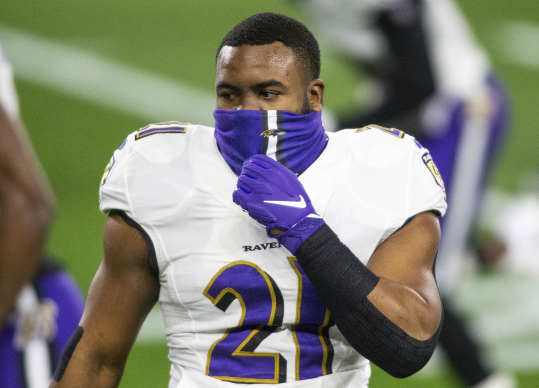 Dec 14, 2020; Cleveland, Ohio, USA; Baltimore Ravens running back Mark Ingram (21) adjusts his face mask before the game against the Cleveland Browns at FirstEnergy Stadium. Mandatory Credit: Scott Galvin-USA TODAY Sports