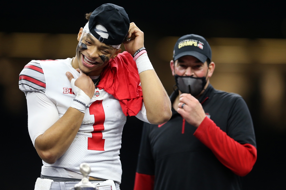 Jan 1, 2021; New Orleans, LA, USA; Ohio State Buckeyes quarterback Justin Fields (1) celebrates with head coach Ryan Day after defeating the Clemson Tigers at Mercedes-Benz Superdome. Mandatory Credit: Chuck Cook-USA TODAY Sports