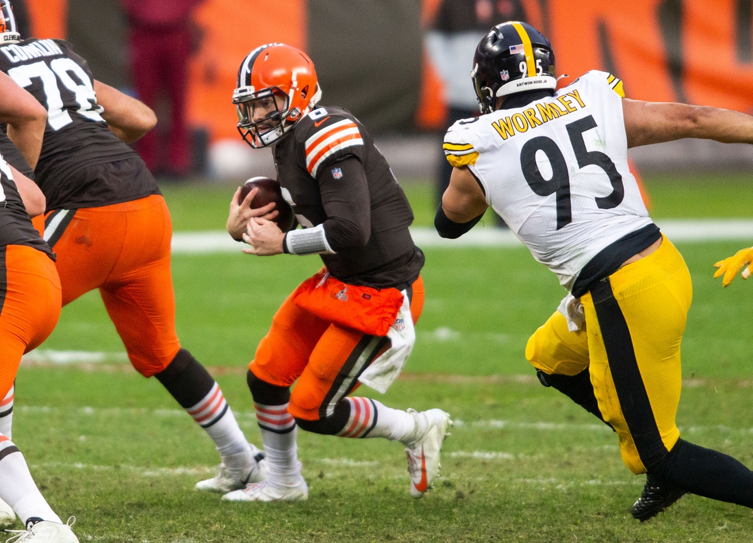 Jan 3, 2021; Cleveland, Ohio, USA; Cleveland Browns quarterback Baker Mayfield (6) runs the ball as Pittsburgh Steelers nose tackle Chris Wormley (95) moves in for the tackle during the fourth quarter at FirstEnergy Stadium. Mandatory Credit: Scott Galvin-USA TODAY Sports