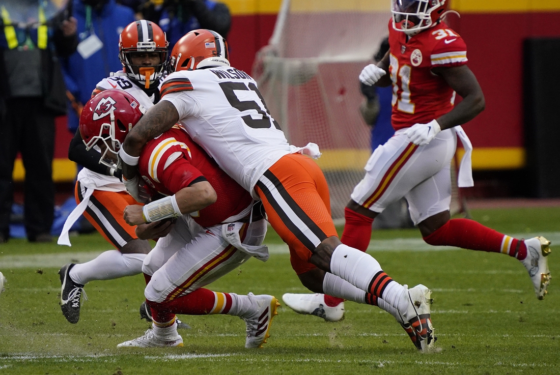 Jan 17, 2021; Kansas City, Missouri, USA; Kansas City Chiefs quarterback Patrick Mahomes (15) is brought down by Cleveland Browns outside linebacker Mack Wilson (51) during the second half in the AFC Divisional Round playoff game at Arrowhead Stadium. Mahomes would suffer an injury on the play.  Mandatory Credit: Jay Biggerstaff-USA TODAY Sports