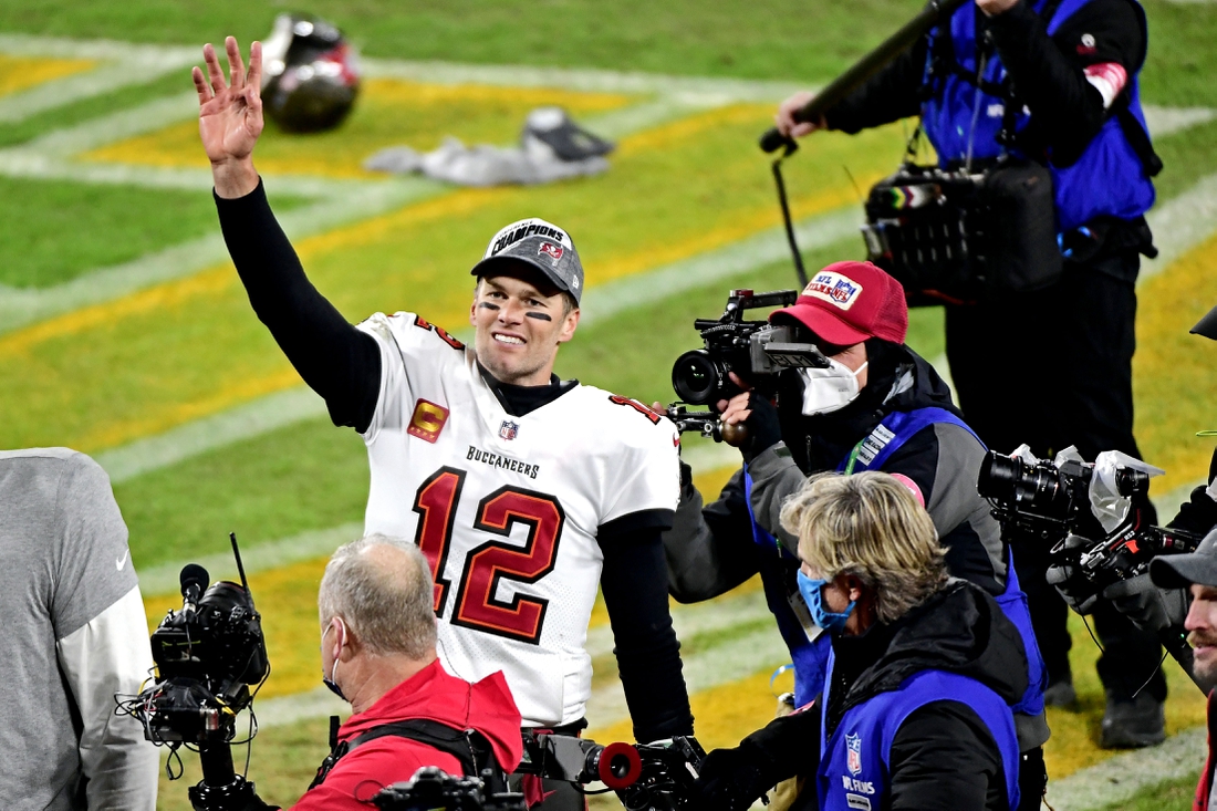 Jan 24, 2021; Green Bay, Wisconsin, USA; Tampa Bay Buccaneers quarterback Tom Brady (12) celebrates after beating the Green Bay Packers in the NFC Championship Game at Lambeau Field . Mandatory Credit: Benny Sieu-USA TODAY Sports