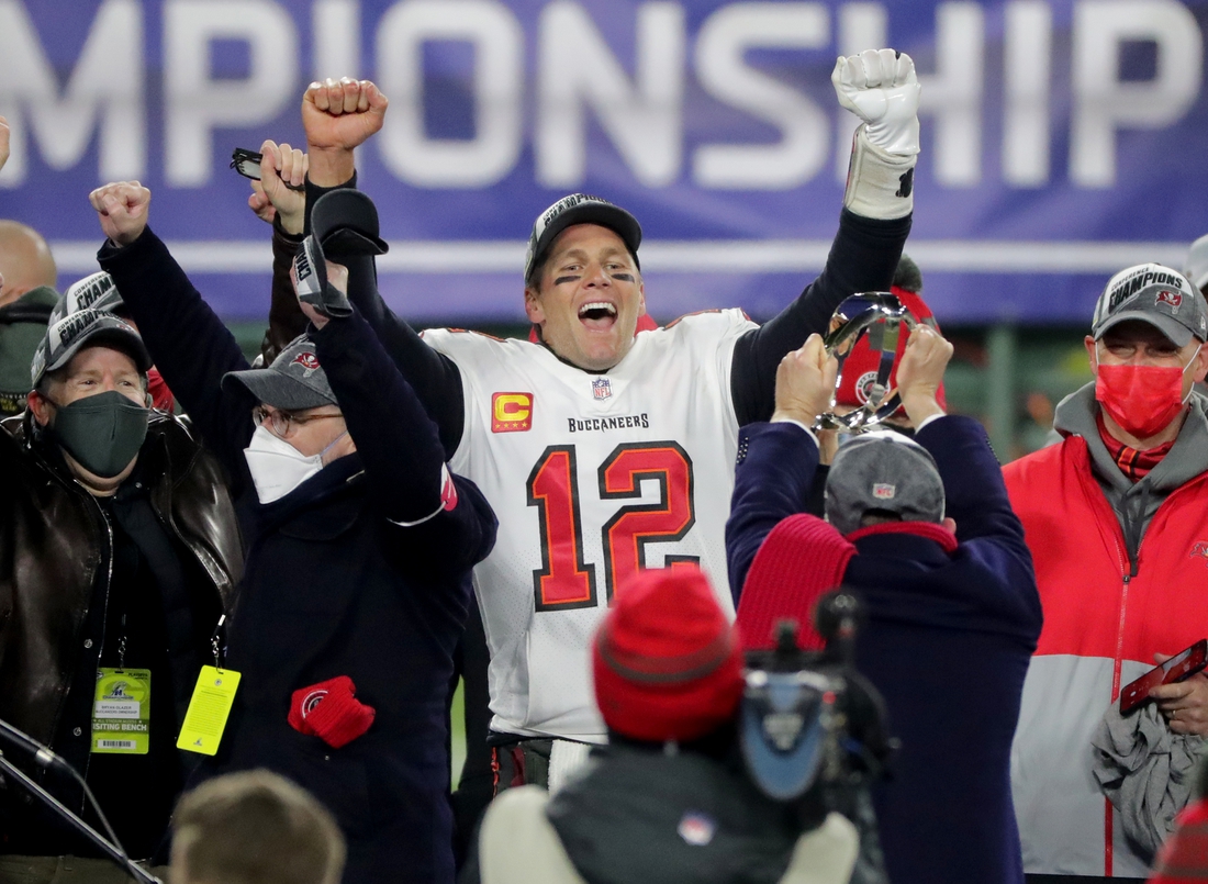 Jan 24, 2021, Green Bay, WI, USA; Tampa Bay Buccaneers quarterback Tom Brady (12) exalts during the presentation off the George Halas Trophy after  their NFC Championship game Sunday, January 24, 2021 at Lambeau Field in Green Bay, Wis. The Tampa Bay Buccaneers beat the Green Bay Packers 31-26. Mandatory credit: Mark Hoffman / Milwaukee Journal Sentinel via USA TODAY NETWORK