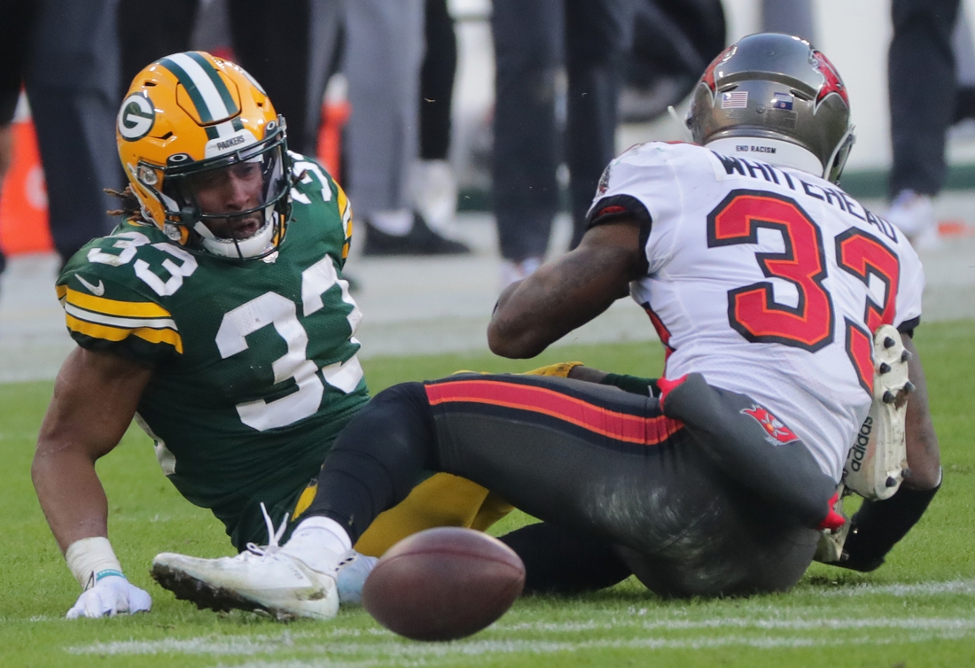 Jan 24, 2021, Green Bay, WI, USA; Green Bay Packers' Aaron Jones (33) fumbles thebasl after being drilled by Tampa Bay Buccaneers free safety Jordan Whitehead (33,white) during the third quarter of their NFC Championship game Sunday, January 24, 2021 at Lambeau Field in Green Bay, Wis. Tampa recovered  the ball and scored on the next play. The Tampa Bay Buccaneers beat the Green Bay Packers 31-26. Mandatory credit: Mark Hoffman / Milwaukee Journal Sentinel via USA TODAY NETWORK