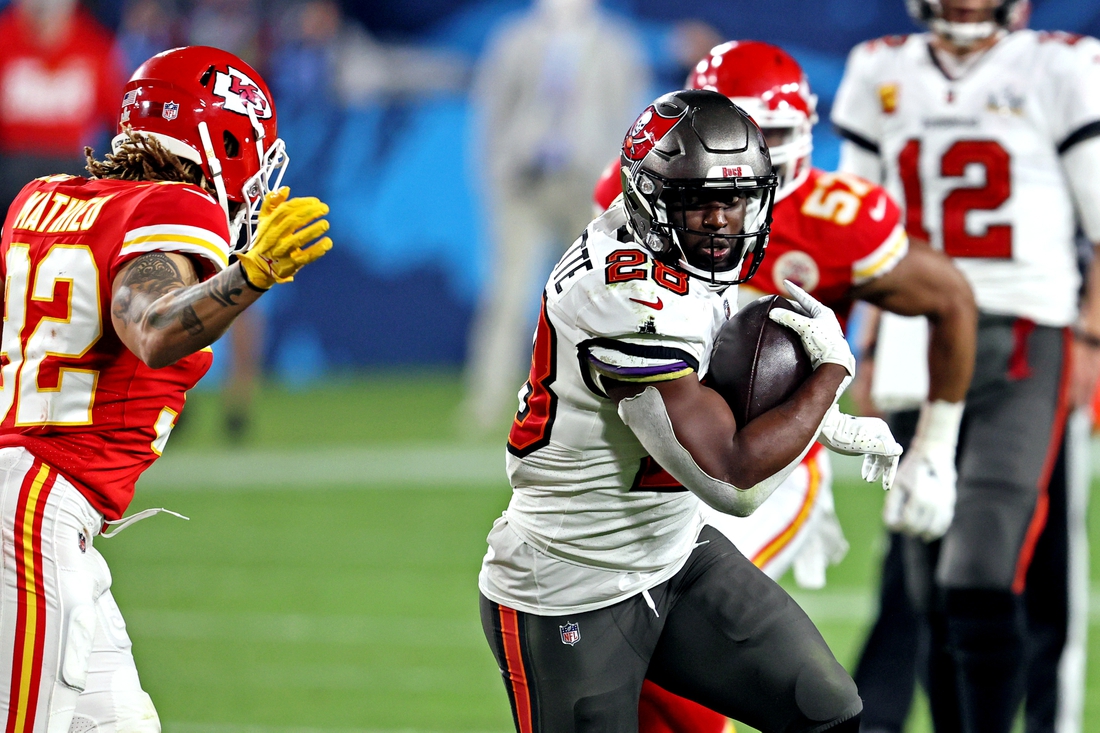 Feb 7, 2021; Tampa, FL, USA;  Tampa Bay Buccaneers running back Leonard Fournette (28) runs the ball against Kansas City Chiefs strong safety Tyrann Mathieu (32) during the fourth quarter in Super Bowl LV at Raymond James Stadium.  Mandatory Credit: Matthew Emmons-USA TODAY Sports