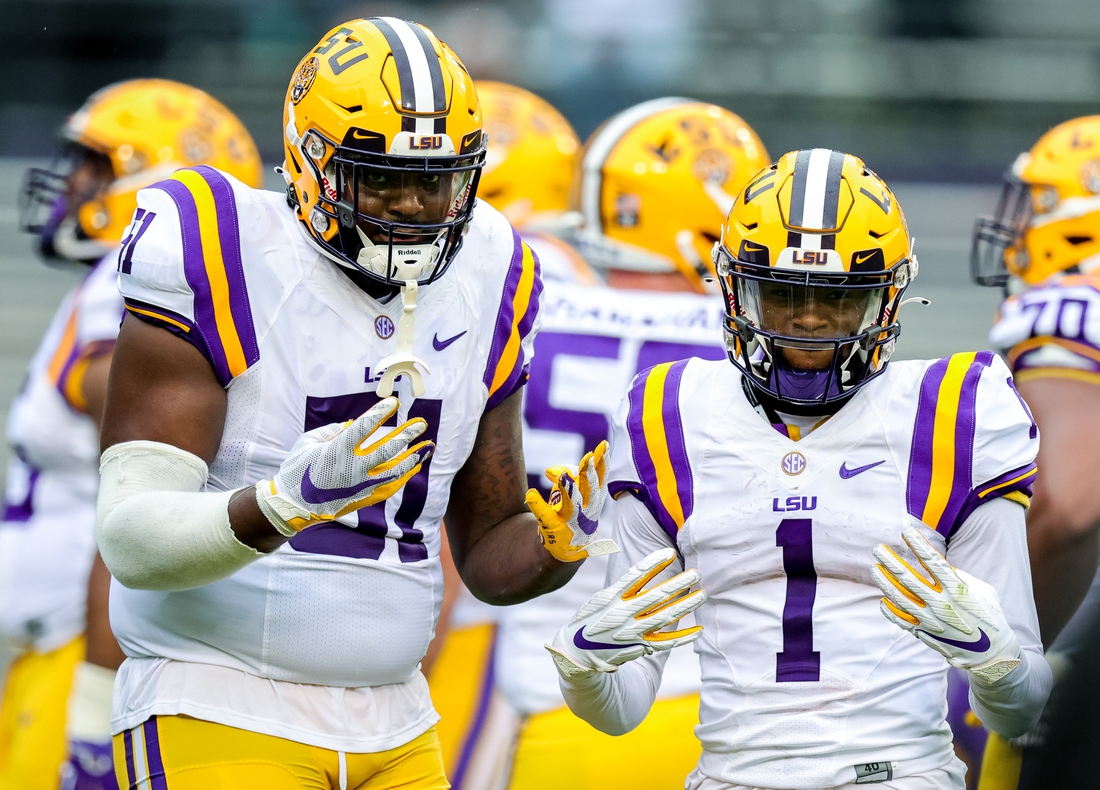 Apr 17, 2021; Baton Rouge, Louisiana, USA;  LSU Tigers offensive tackle Dare Rosenthal (51) and LSU Tigers wide receiver Kayshon Boutte (1) pose for the camera on a time out during the first half of the annual Purple and White spring game at Tiger Stadium. Mandatory Credit: Stephen Lew-USA TODAY Sports