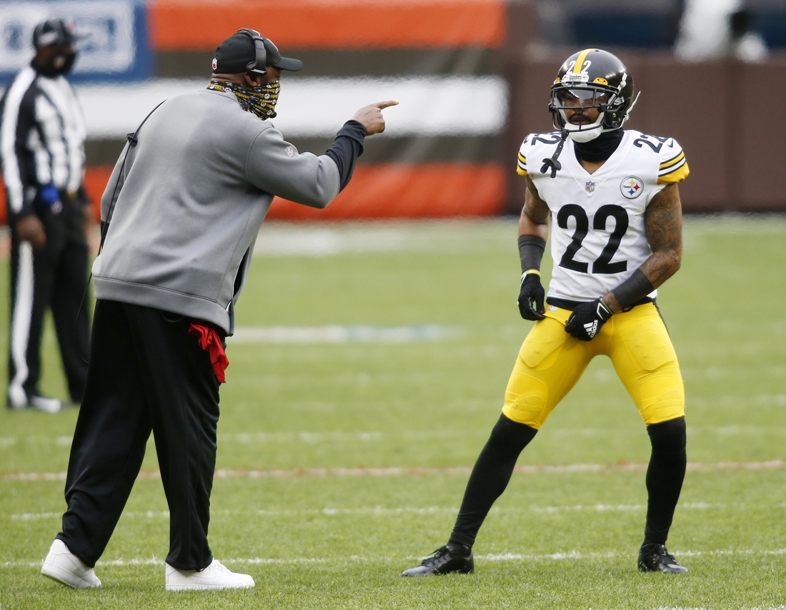 Jan 3, 2021; Cleveland, Ohio, USA; Pittsburgh Steelers head coach Mike Tomlin talks with cornerback Steven Nelson (22) during the first quarter against the Cleveland Browns at FirstEnergy Stadium. Mandatory Credit: Scott Galvin-USA TODAY Sports