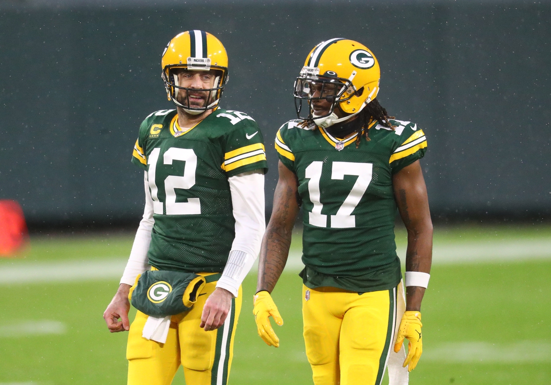 Jan 16, 2021; Green Bay, Wisconsin, USA; Green Bay Packers quarterback Aaron Rodgers (12) and wide receiver Davante Adams (17) against the Los Angeles Rams during the NFC Divisional Round at Lambeau Field. Mandatory Credit: Mark J. Rebilas-USA TODAY Sports