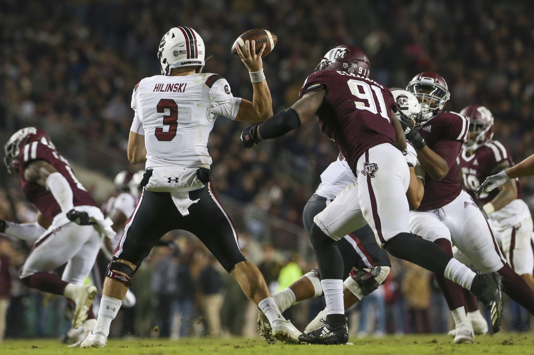 Nov 16, 2019; College Station, TX, USA; South Carolina Gamecocks quarterback Ryan Hilinski (3) looks to throw pursued by Texas A&M Aggies defensive lineman Micheal Clemons (91) during the third quarter at Kyle Field. Mandatory Credit: John Glaser-USA TODAY Sports
