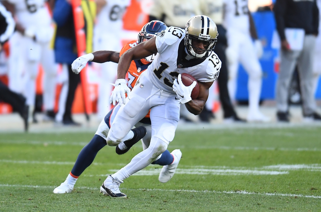 Nov 29, 2020; Denver, Colorado, USA; New Orleans Saints wide receiver Michael Thomas (13) carries the ball against the Denver Broncos in the second quarter at Empower Field at Mile High. Mandatory Credit: Ron Chenoy-USA TODAY Sports