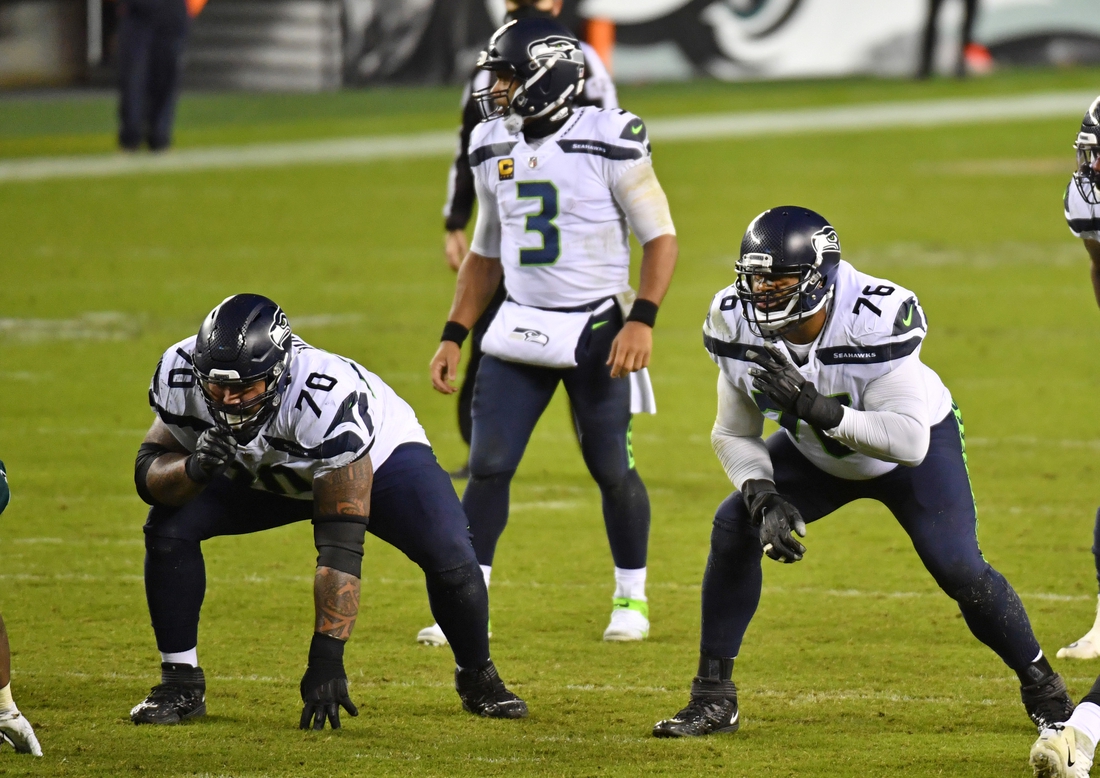 Nov 30, 2020; Philadelphia, Pennsylvania, USA; Seattle Seahawks offensive guard Mike Iupati (70) and offensive tackle Duane Brown (76) wait for the snap against the Philadelphia Eagles at Lincoln Financial Field. Mandatory Credit: Eric Hartline-USA TODAY Sports
