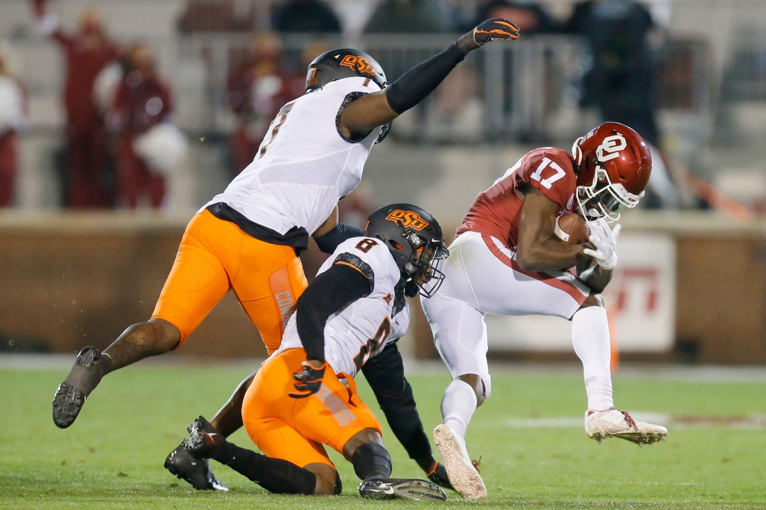 Oklahoma's Marvin Mims (17) catches the ball in front of Oklahoma State's Amen Ogbongbemiga (7) and Rodarius Williams (8) during a Bedlam college football game between the University of Oklahoma Sooners (OU) and the Oklahoma State Cowboys (OSU) at Gaylord Family-Oklahoma Memorial Stadium in Norman, Okla., Saturday, Nov. 21, 2020. Oklahoma won 41-13. [Bryan Terry/The Oklahoman]

Photo 5