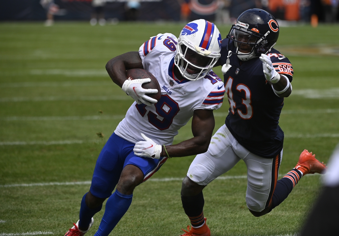 Aug 21, 2021; Chicago, Illinois, USA;  Buffalo Bills wide receiver Isaiah McKenzie (19) runs with the ball against Chicago Bears defensive back Marqui Christian (43) during the first half at Soldier Field. Mandatory Credit: Matt Marton-USA TODAY Sports