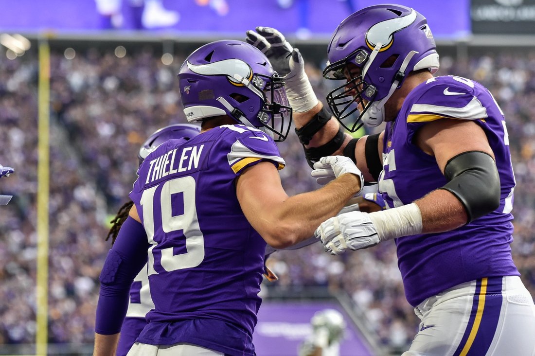 Sep 22, 2019; Minneapolis, MN, USA; Minnesota Vikings wide receiver Adam Thielen (19) reacts with offensive tackle Brian O'Neill (75) after catching a 35 yard touchdown pass from quarterback Kirk Cousins (not shown) against the Oakland Raiders during the first quarter at U.S. Bank Stadium. Mandatory Credit: Jeffrey Becker-USA TODAY Sports